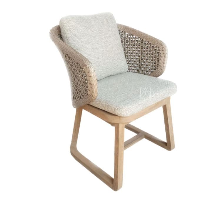 A modern armchair with a woven rattan back and sides, a cushioned seat and backrest, and a light wood frame. The armchair has curved armrests and a contemporary aesthetic, suitable for indoor or outdoor use. — 3D model
