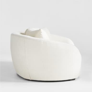 A modern three-seater sofa with a curved silhouette and plush upholstery. It features three loose back cushions and a continuous seat cushion. The arms are rounded and integrated into the overall curved design. The upholstery appears to be a textured fabric, possibly boucle or sherpa, in a light cream color. — 3D model