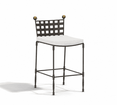 A tall bar stool featuring a dark wrought iron frame with a distinctive woven grid backrest and two spherical brass finials. The seat is cushioned and upholstered in a light-colored fabric, likely off-white or cream. The legs are slender, with some turned details towards the bottom, and include a square footrest for support. — 3D model