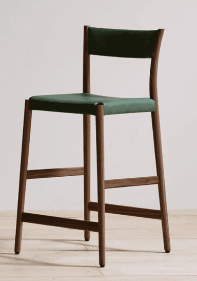 A contemporary bar stool with a wooden frame and a black upholstered seat and backrest. The stool features a curved backrest that extends from the frame. The legs are made of light-colored wood and are connected by horizontal support rails, providing stability. The seat and backrest appear to be upholstered in a dark, possibly leather, material. — 3D model
