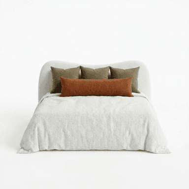 A bed with a curved, upholstered headboard and a light-colored textured comforter. It is adorned with several decorative pillows: a long lumbar pillow in a rust color, and three square pillows in an olive green hue, arranged behind the lumbar pillow. The bed appears to be a queen or king size. — 3D model