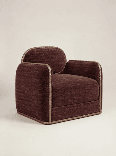 A contemporary upholstered armchair featuring a deep plum or burgundy textured fabric. It is characterized by a unique, decorative hammered metal frame that outlines the oval backrest, armrests, and base, providing a distinct stylistic element and material contrast. The seat cushion is integrated, presenting a substantial and refined form. — 3D model