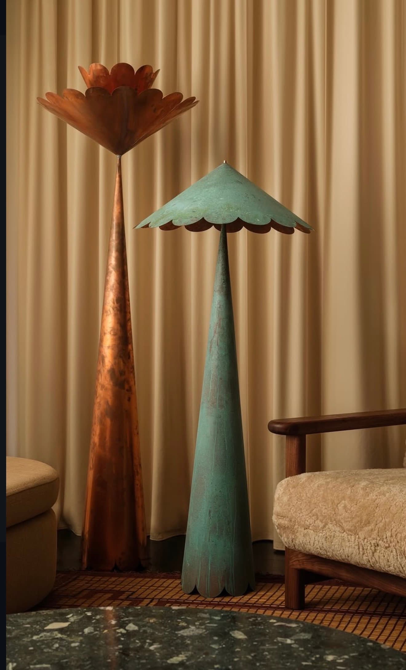 Two tall, sculptural floor lamps crafted from metal, featuring conical bases and distinct scalloped shades. One lamp exhibits a warm, burnished copper tone, while the other is finished with a mottled, aged verdigris patina. Both shades are wide and shallow with wavy, petal-like edges, supported by slender conical stems that widen into stable bases. They appear to be a matching set with differing finishes. — 3D model