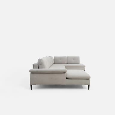 A U-shaped sectional sofa with light grey fabric upholstery. The sofa features tufted back cushions and a chaise lounge on one end and a rounded armrest on the other. It is supported by dark, tapered legs. — 3D model