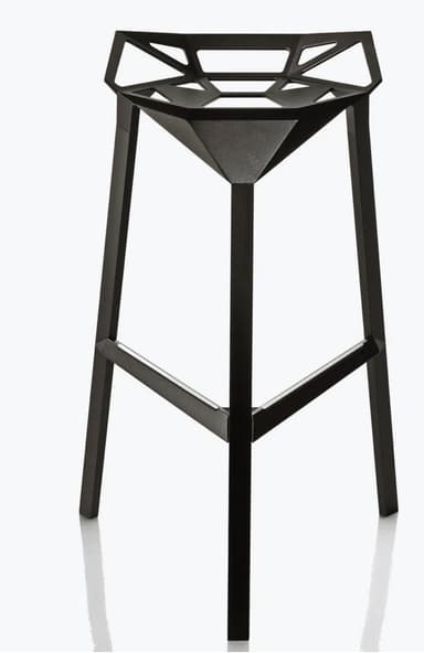 A modern bar stool with a geometric, faceted seat and a matte black finish. It features three angled legs connected by a lower support structure. The seat has an open, angular design with triangular and hexagonal cutouts. — 3D model