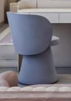 A modern, fully upholstered chair featuring a rounded backrest and a circular seat, supported by a wide, tapered conical pedestal base. The entire piece is upholstered in a smooth, light blue fabric, presenting a monolithic and sculptural form. — 3D model