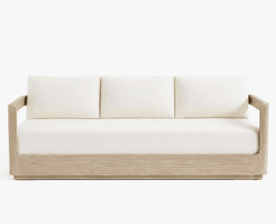 A three-seater sofa with a light wood frame and off-white cushions. The frame has a clean, minimalist design with straight lines. The seat and back cushions appear to be upholstered in a fabric. — 3D model