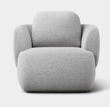 A contemporary, heavily upholstered lounge chair featuring an organic, rounded form. The chair is covered in a plush, textured boucle-like fabric in a light grey or off-white color. It has a low profile with no visible legs, appearing to sit directly on the floor or a very subtle plinth base. The backrest and armrests are integrated into the continuous, fluid shape, emphasizing comfort and softness. — 3D model