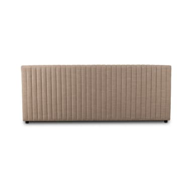 A rectangular upholstered headboard with vertical channel tufting. The headboard has a flat top edge and appears to be designed to attach to a bed frame or wall. It rests on small, dark-colored feet. — 3D model