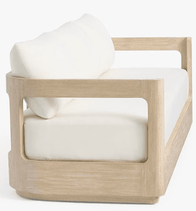 A three-seater sofa with a light wood frame and off-white cushions. The frame has a clean, minimalist design with straight lines. The seat and back cushions appear to be upholstered in a fabric. — 3D model