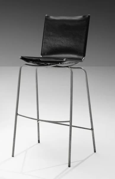A bar stool with a black seat and backrest, supported by a thin, metallic frame with four legs connected by a crossbar for stability. The seat appears to be upholstered. — 3D model