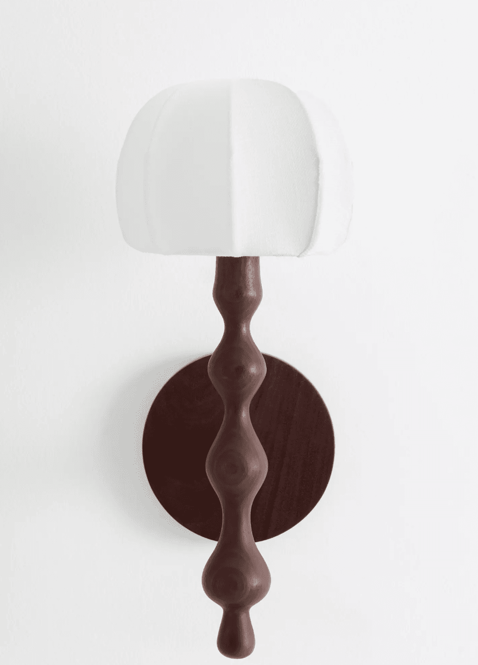 A wall-mounted lighting fixture featuring a circular dark wood backplate and a sinuously turned wooden arm, topped with an off-white, segmented fabric shade. The design is sculptural and organic. — 3D model