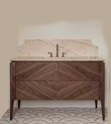A contemporary bathroom vanity featuring a dark walnut wood cabinet, a light marble countertop with an integrated undermount sink, and a decorative marble backsplash. The cabinet displays a distinct chevron wood grain pattern on its two drawer fronts and stands on four tapered, splayed legs. A three-piece brass faucet set completes the unit. — 3D model