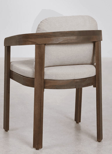 A modern armchair featuring a dark-stained wooden frame and light beige fabric upholstery. The chair includes separate, removable cushions for the seat and back, both with rounded edges. The wooden frame consists of straight legs, a solid seat base, and gently curved armrests that seamlessly integrate into the backrest supports. The overall design emphasizes clean lines and a minimalist aesthetic. — 3D model