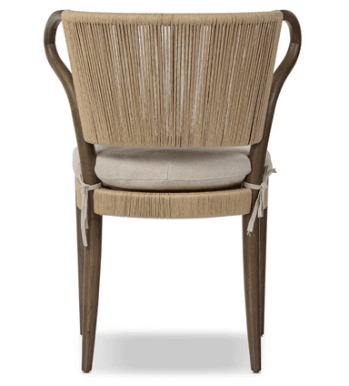 A dining chair with a wooden frame. The backrest is constructed from tightly woven rope or cord in a vertical pattern, extending from the seat base to the curved top of the backrest. The seat is cushioned and upholstered in a textured fabric. The chair has four wooden legs, with the front legs being straight and the back legs tapering slightly. The armrests are integrated into the wooden frame and curve upwards. — 3D model