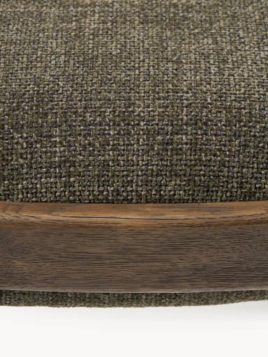A rectangular upholstered ottoman featuring a solid wooden frame with rounded edges and four tapered legs. The top is generously padded and covered in a textured, greenish-brown fabric, while horizontal wooden stretchers provide structural support. — 3D model