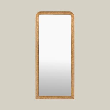 A tall, rectangular wall mirror featuring rounded top corners and an intricately carved, gilded frame. The frame displays elaborate floral and foliate motifs, characteristic of traditional or classical design styles, rendered in an antique gold finish. The mirror surface itself is a standard reflective glass. — 3D model