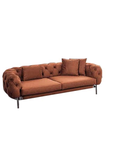 A contemporary chaise lounge upholstered in tufted rust-brown velvet, featuring a curved design and supported by thin black metal legs. Includes two matching toss pillows. — 3D model
