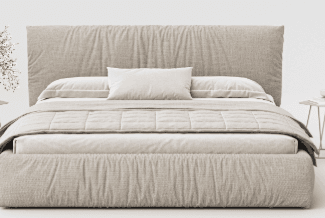 A king-size upholstered bed frame with a plush headboard featuring a ruched or gathered fabric design. The bed is dressed with white bedding, a decorative pillow, and a quilted throw blanket. It sits on a solid base and is flanked by two small, modern side tables, one holding a vase with floral sprigs and the other a cup and saucer. — 3D model