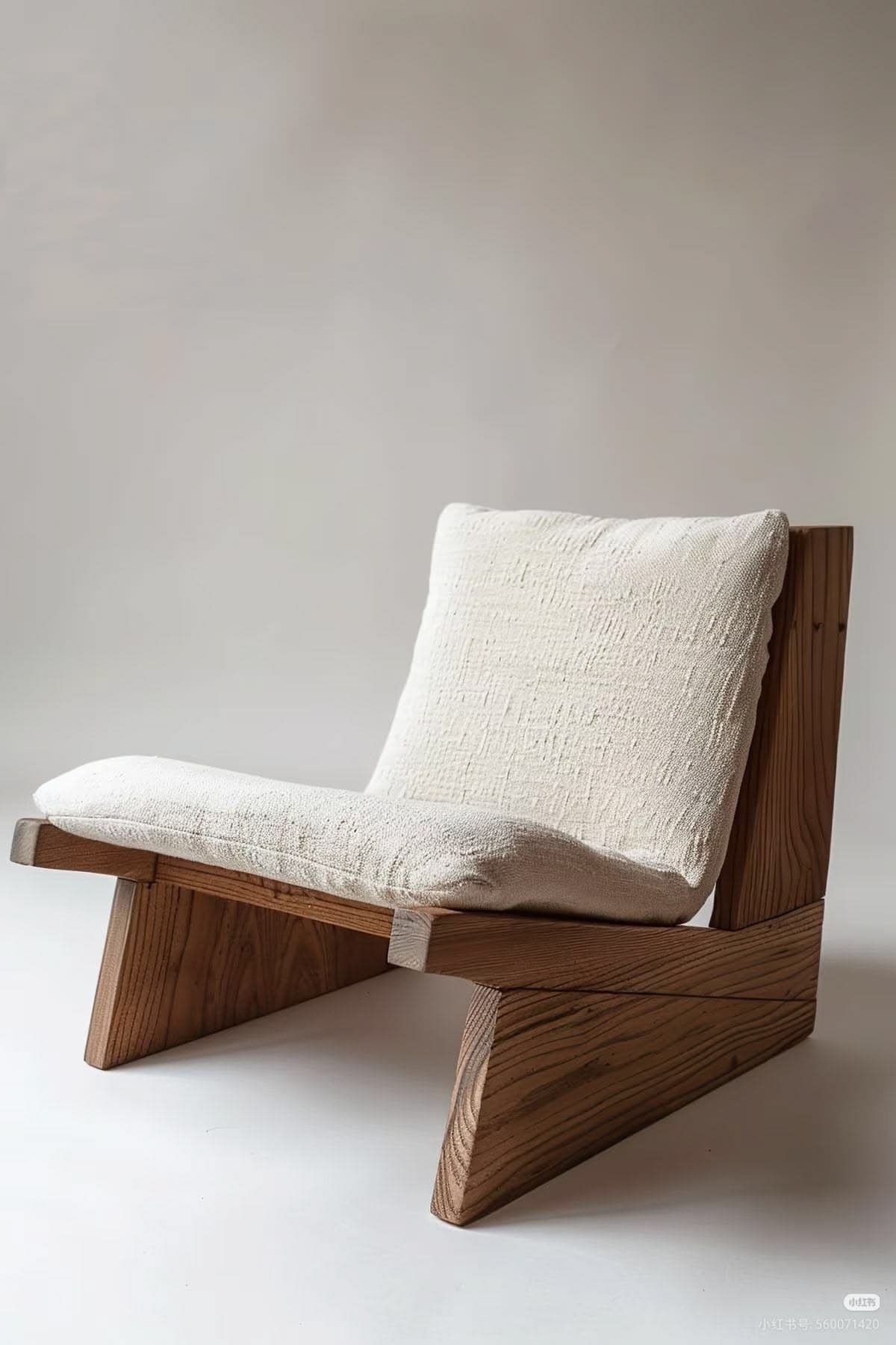 A low-profile lounge chair featuring a sturdy, angular frame constructed from thick planks of light-toned solid wood. It is fitted with generously thick seat and back cushions upholstered in a textured, off-white fabric. The design emphasizes clean lines, natural materials, and a minimalist aesthetic. — 3D model