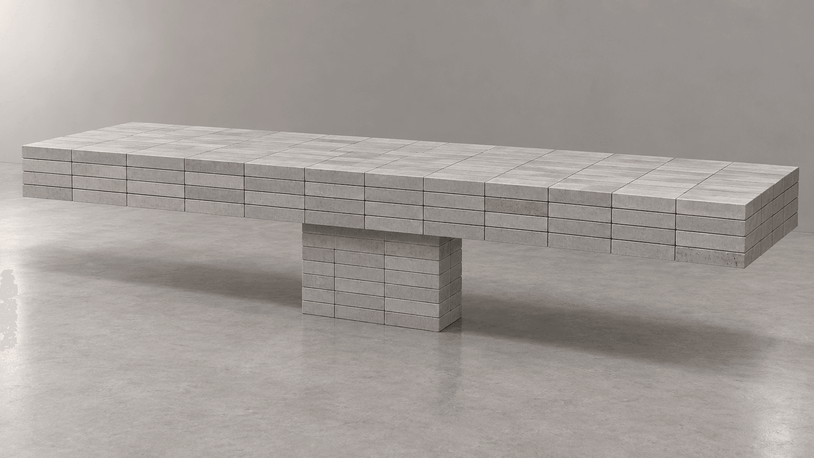 A long, rectangular, low-profile bench constructed from numerous modular rectangular blocks, likely concrete or a stone composite, forming a solid, architectural structure with a central pedestal base. — 3D model