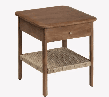A square-top nightstand crafted from wood, featuring a single storage drawer with a brass knob and a lower shelf made from woven rattan or jute. The tabletop corners are rounded, and the legs are straight, giving it a clean, contemporary appearance. — 3D model
