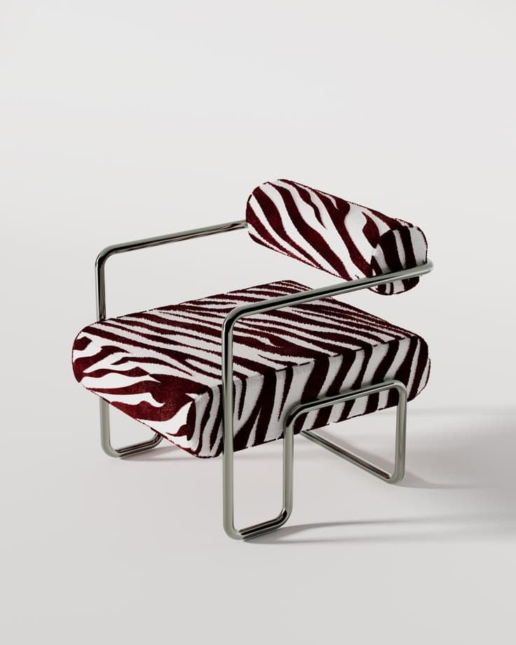 A striking lounge chair featuring a polished tubular steel frame and bold zebra-print upholstery in dark red and white. It has a low-profile design with a rectangular seat cushion and a cylindrical back bolster. — 3D model