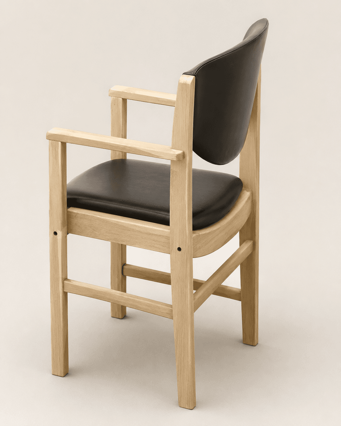 A modern armchair featuring a solid light-colored wooden frame with black padded upholstery on both the seat and the backrest. The design is characterized by clean lines, a slightly curved backrest, and integrated rectangular armrests. The frame appears to be made of light-toned wood, likely oak, with visible grain patterns and simple joint detailing. — 3D model