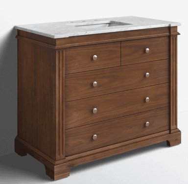 A traditional style bathroom vanity constructed from rich brown wood, featuring a white marble countertop with an integrated sink basin. The vanity has a rectangular form with fluted pilaster details on the side stiles and rests on a plinth base. It is equipped with multiple drawers of varying sizes, each fitted with round, satin brass-toned knobs. — 3D model