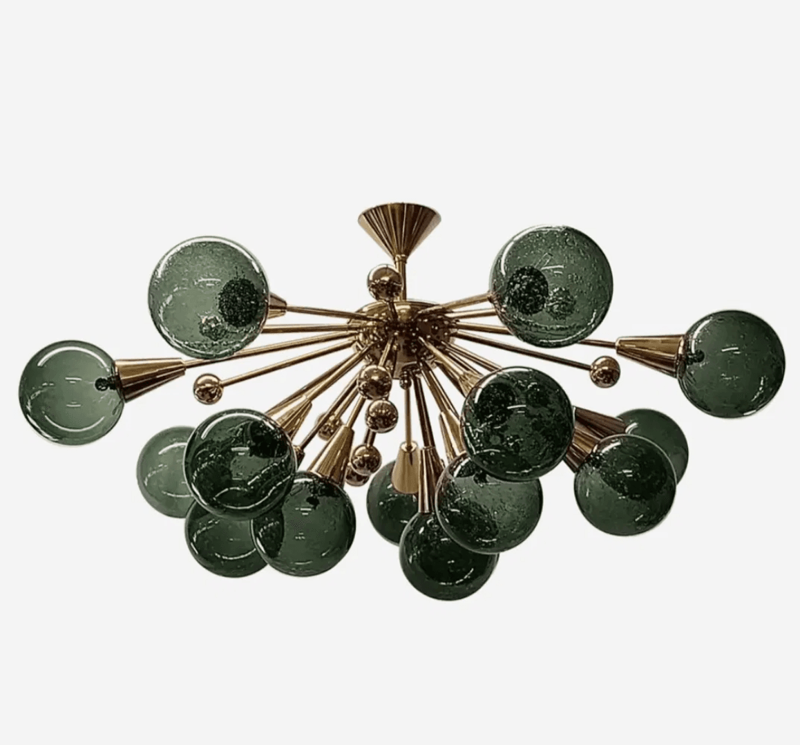 A striking modern Sputnik chandelier featuring a central brass hub with multiple radial arms, each terminating in a textured dark green glass sphere. The design creates an explosive, starburst-like silhouette. — 3D model