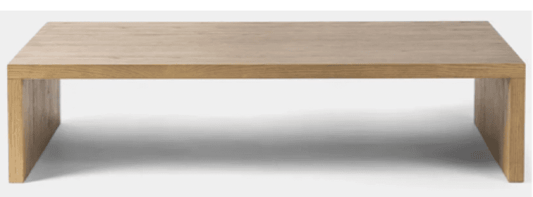 A rectangular coffee table constructed entirely from light-colored solid wood, featuring a minimalist slab design. The tabletop and legs form a continuous, block-like structure with visible wood grain. — 3D model