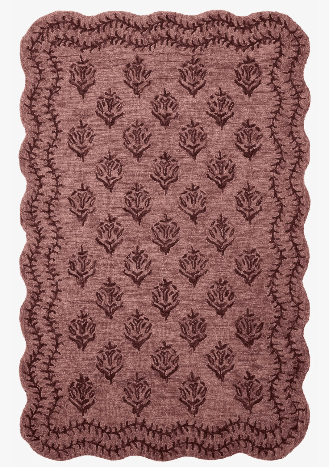 A small rectangular textile mat featuring a scalloped edge and an embossed or woven floral pattern across its surface. The mat is a muted brownish-mauve color, suggesting a soft, possibly plush texture. The floral motif consists of repeated rose-like designs arranged in a grid, contrasting subtly with the background texture. The edges are finished with a distinct scalloped border, adding a decorative touch. — 3D model