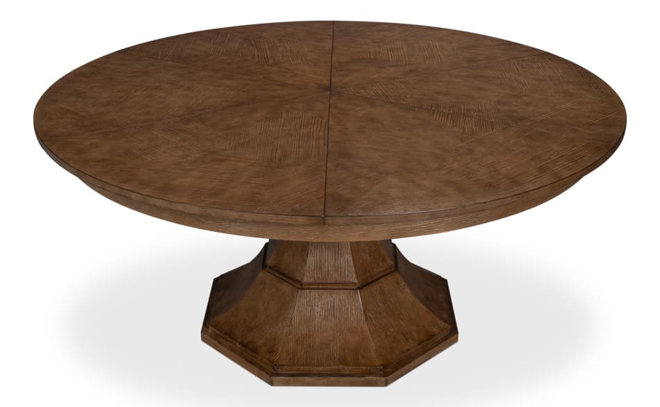 A round dining table with a pedestal base. The tabletop is constructed from segmented wooden panels arranged in a starburst pattern. The pedestal base is octagonal and has a faceted design. The wood exhibits a visible grain texture and a medium brown finish. — 3D model