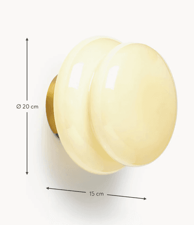 A wall-mounted lighting fixture featuring two concentric, overlapping, dome-shaped diffusers made of opaque, creamy white glass, set against a circular brass base. The overall form is organic and sculptural. — 3D model