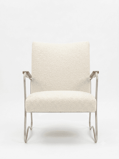 A contemporary armchair featuring an off-white bouclé upholstery on the seat and backrest, supported by a bent tubular metal frame. The armrests have wooden caps. The frame forms a continuous, sled-like base. — 3D model