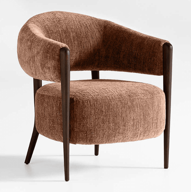 A contemporary barrel armchair featuring a fully upholstered body with a curved backrest and integrated arms, set upon a dark-stained wooden frame. The upholstery is a textured reddish-brown fabric, complementing the dark wood legs. — 3D model