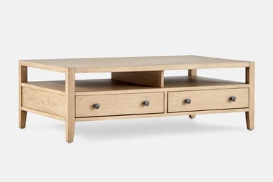 A light-colored wooden coffee table with a rectangular top and an open lower shelf. It features three drawers with dark, circular knobs. The overall design is minimalist with clean lines and tapered legs. — 3D model