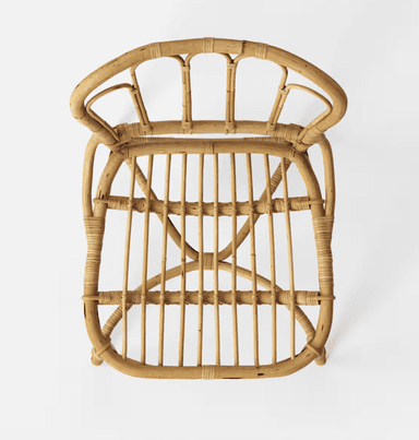 A vintage-style side chair constructed entirely from natural rattan. The chair features a curved backrest with vertical spindles and a woven seat. The legs are joined by a curved stretcher and a lower crossbar for stability. — 3D model