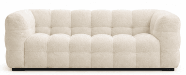 A modern three-seater sofa upholstered in a creamy, off-white boucle fabric. The sofa features a distinctive tufted design, creating a plush, segmented appearance across the backrest, seat, and arms. It has low, rounded arms and a solid, block-style base in black or dark brown, providing a contemporary aesthetic. — 3D model