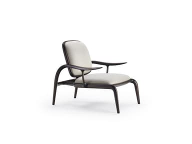 A lounge chair featuring a dark-stained sculpted wooden frame with a light blue upholstered seat and back. The frame exhibits fluid, organic curves, particularly in its armrests and integrated legs. — 3D model