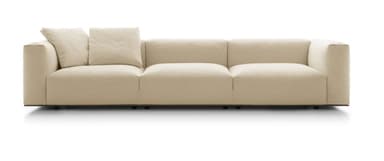 A contemporary three-seater sofa upholstered in a cream-colored boucle fabric. It features a low-profile design with three distinct seat cushions and two loose back cushions, along with wide, block-style arms. The sofa rests on discreet, low-set dark feet. — 3D model