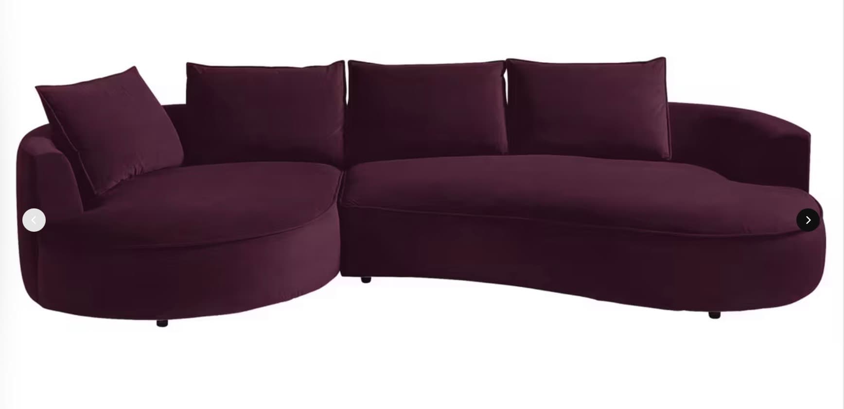 A large, contemporary curved sectional sofa featuring a deep purple fabric upholstery. The sofa includes an integrated round chaise lounge component on one end, transitioning into a curved seating section. It is furnished with multiple loose back cushions and accent pillows, all matching the deep purple upholstery. The design incorporates a low profile with recessed feet, giving it a floating appearance. — 3D model