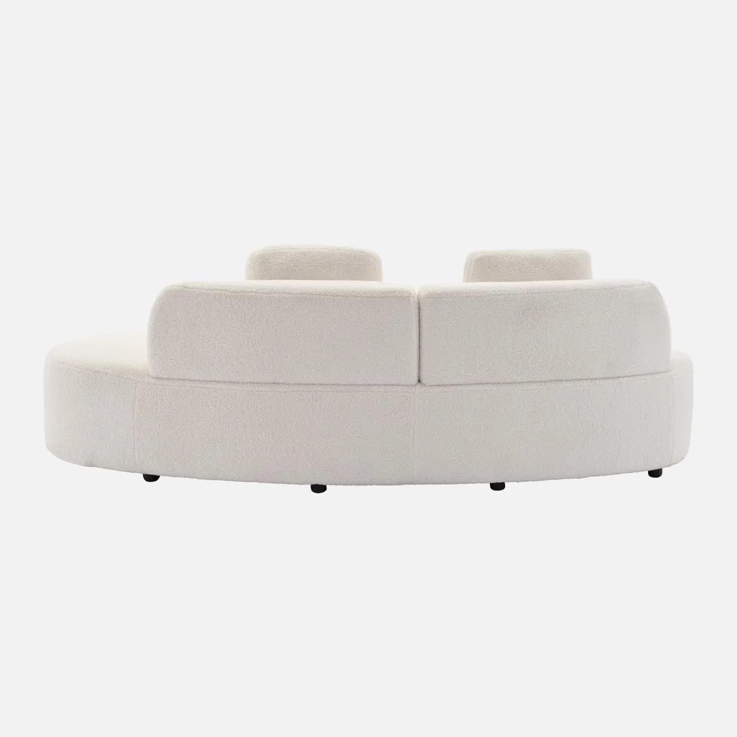 A cream-colored, curved sofa with a textured fabric upholstery, possibly bouclé or sherpa. It features a rounded silhouette and appears to have separate seating sections. The backrest is segmented and slightly curved, with two distinct upright back cushions visible. The sofa sits on low, dark-colored legs. — 3D model