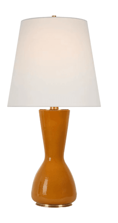 A table lamp featuring a glossy, caramel-colored ceramic base shaped like a gourd, accented with brass-finished details, and topped with a white tapered drum shade. — 3D model
