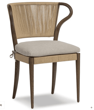 A dining chair with a wooden frame. The backrest is constructed from tightly woven rope or cord in a vertical pattern, extending from the seat base to the curved top of the backrest. The seat is cushioned and upholstered in a textured fabric. The chair has four wooden legs, with the front legs being straight and the back legs tapering slightly. The armrests are integrated into the wooden frame and curve upwards. — 3D model