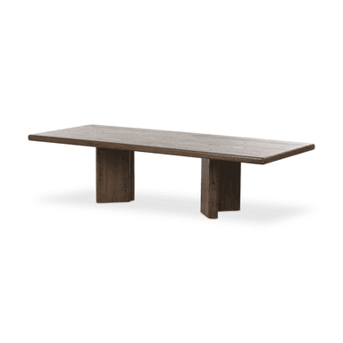 A rectangular dining table with a thick, solid wood top featuring a light, weathered finish and pronounced wood grain patterns. The base consists of two substantial, vertical wooden supports with rounded edges, finished in a darker, rich brown tone. The overall design evokes a rustic or natural aesthetic. — 3D model
