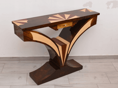 An elegant console table featuring a dark wood finish adorned with intricate marquetry. The rectangular tabletop displays a central sunburst pattern, flanked by geometric designs in contrasting lighter wood. The table's base consists of two large, sweeping curved supports that meet at a central point and transition into a sturdy, ornate plinth. These legs are also embellished with contrasting wood inlays that highlight their graceful, sculptural form. A single, small drawer with a simple pull is subtly integrated beneath the tabletop. — 3D model