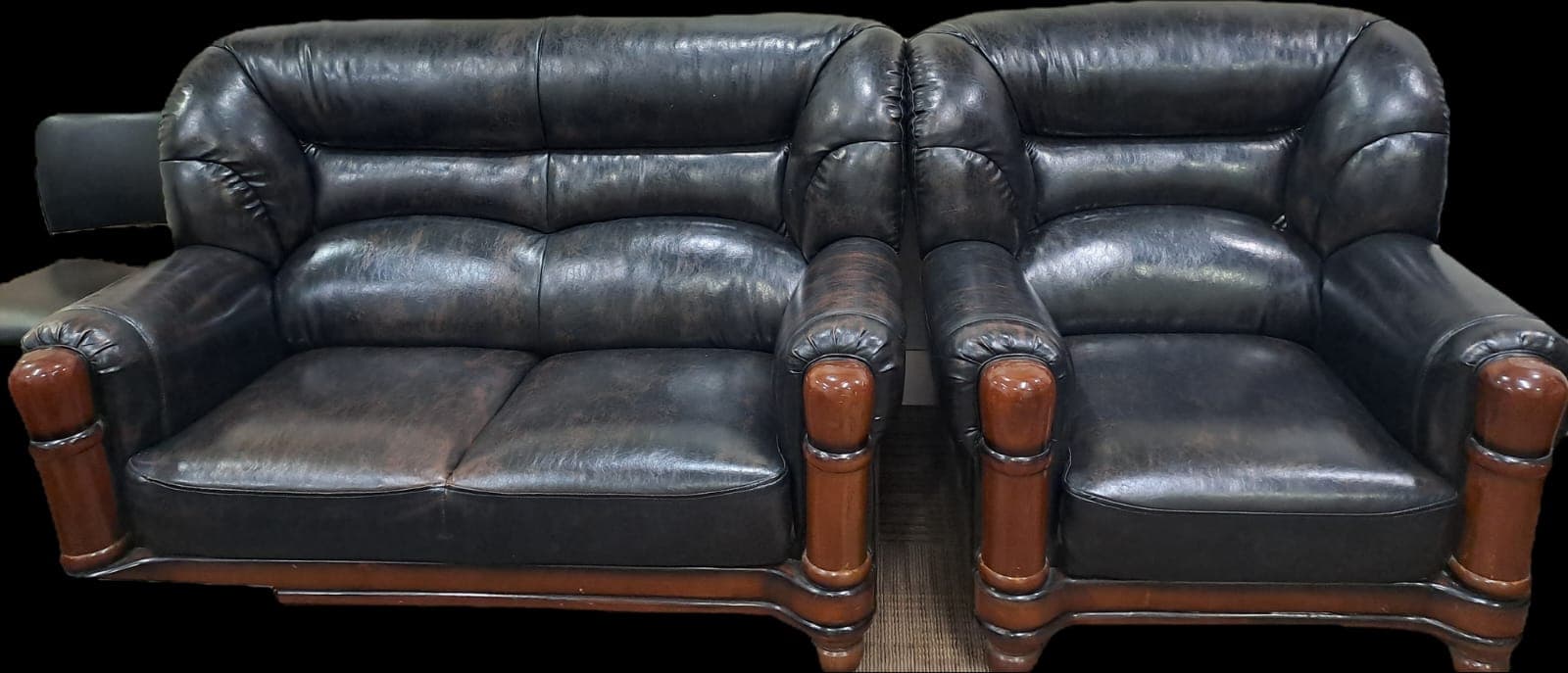 A traditional-style two-seater loveseat upholstered in dark, possibly distressed, leather. It features rolled arms, a button-tufted backrest, and exposed turned wooden legs and frame accents. — 3D model