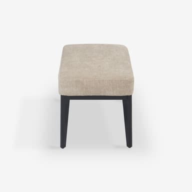 A modern rectangular upholstered bench featuring a light beige fabric cushion atop a dark, likely wooden, frame with four tapered legs. The design is simple and minimalist. — 3D model