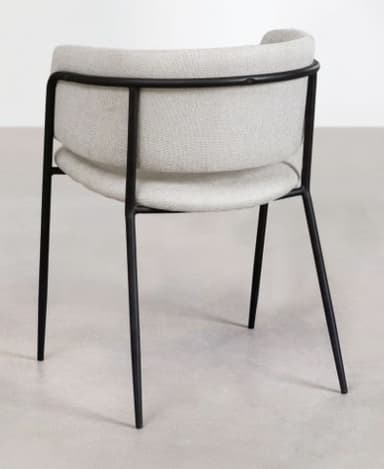 A minimalist dining armchair featuring a slender black metal frame and light grey upholstered seat and backrest. The backrest is gently curved, providing integrated arm support as it wraps around the sides. The seat cushion is separate from the backrest, with a slight gap visible between the two elements. The four tapered metal legs splay slightly outwards, contributing to a modern aesthetic. — 3D model